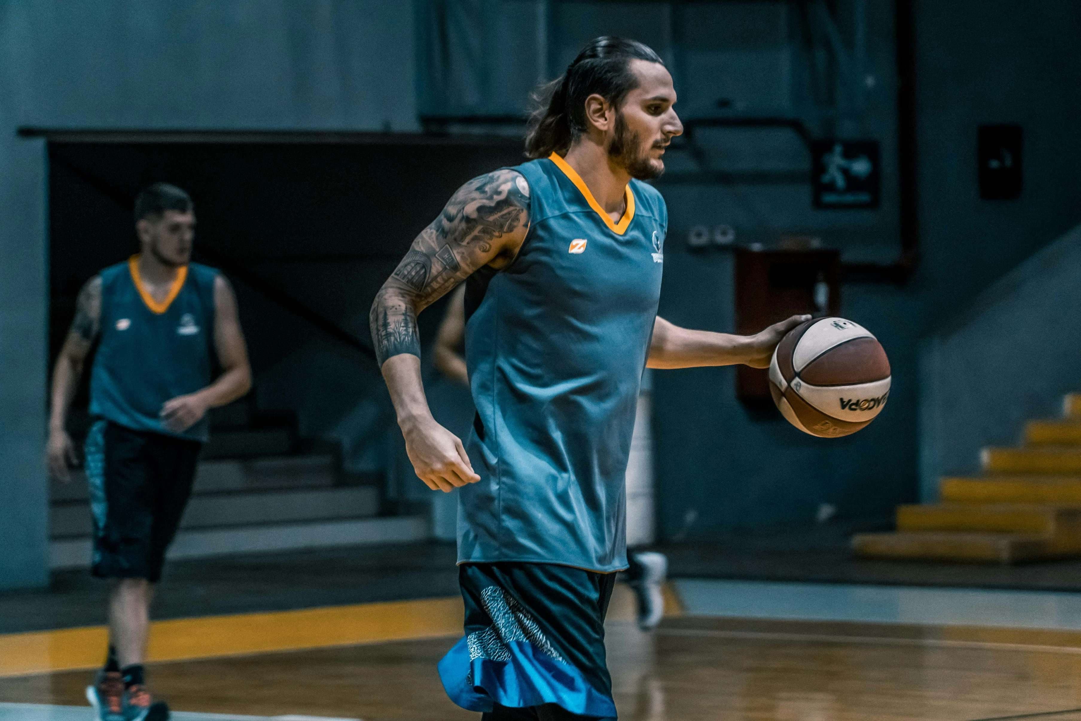 Athlete playing basketball in an indoor arena